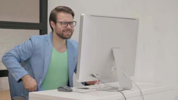 Young Man Having Back Pain While Working Desktop — Stock Video