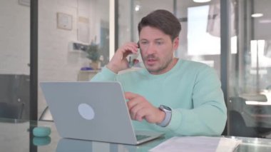Casual Man Talking on Phone, Discussing Work