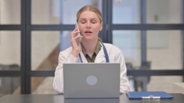 Bayan Doktor Telefonla Konuşuyor ve Laptop Kullanıyor