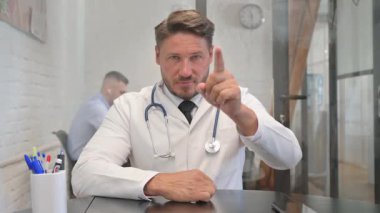 Portrait of Male Doctor Pointing at Camera