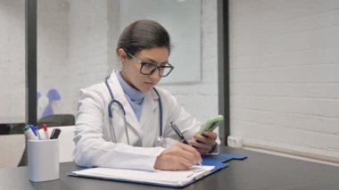 Hintli genç doktor yazıyor. Tıbbi rapor üzerinde çalışıyor.