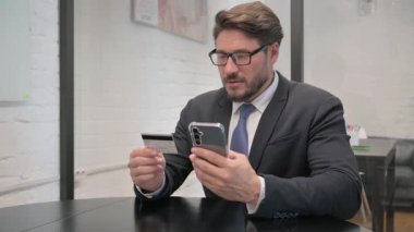 Mutlu Orta Çağ İşadamı Akıllı Telefonla İnternetten Alışveriş Yapıyor