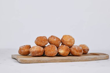 German traditional 'Berliner Pfannkuchen', a donut without hole filled with jam on wooden cutting board