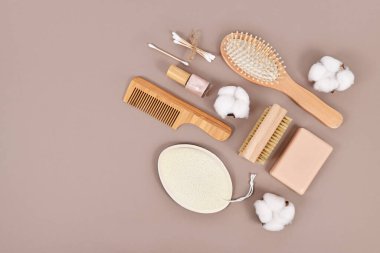 Eco friendly wooden beauty and hygiene products like comb and soap with copy space