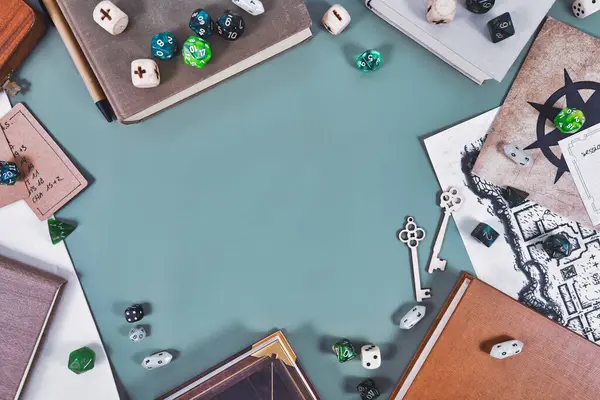 Tabletop role playing flat lay background with colorful RPG dices, rule books, dungeon map forming frame around blue negative spac