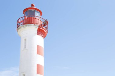 Red and white lighthouse in La Rochelle old harbor, France