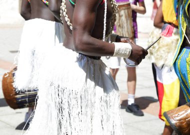 Dansçılar Kenya, Afrika 'dan geleneksel halk kostümlerinden birini giyip dans ediyorlar.