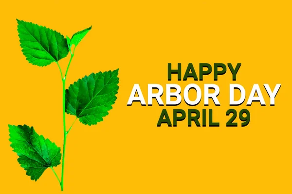 Happy Arbor Day. April 29. Green leaves on yellow background with copy space.