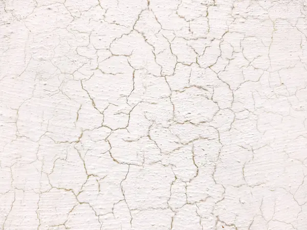 Beyaz duvardaki eski çatlak boya. Tasarım için soyut arkaplan ve doku.