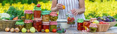 Woman with jar preserved vegetables for winter. Selective focus. Food.