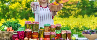 Woman with jar preserved vegetables for winter. Selective focus. Food.