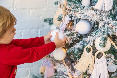 Çocuk Noel ağacına bir süs astı. Seçici odaklanma. Çocuk.