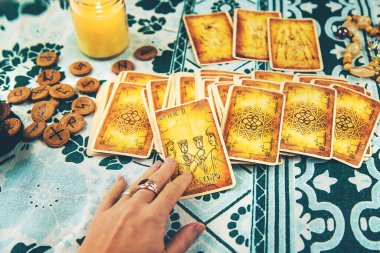 Bir falcı tarot kartlarıyla okur. Seçici odaklanma. Kadın.