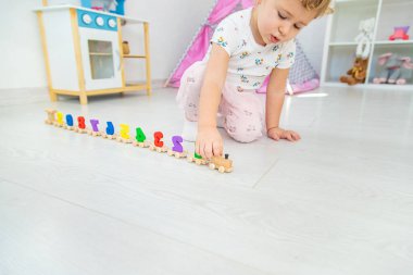A child plays with a train made of numbers. Selective focus. Kid.