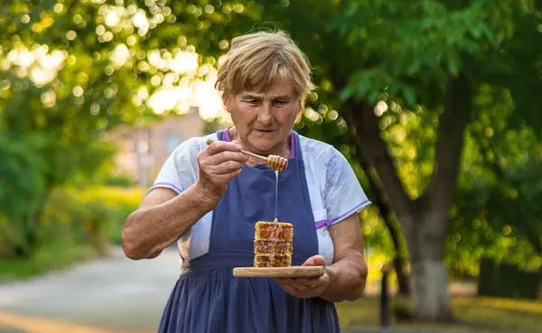 Elderly Woman Holds Honey Her Hands Selective Focus People — Stock Photo, Image