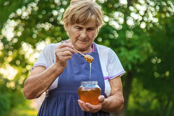 Elderly Woman Holds Honey Her Hands Selective Focus People — Stock Photo, Image