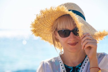 Deniz kıyısında şapkalı bir kadın. Seçici odaklanma. Çocuk.