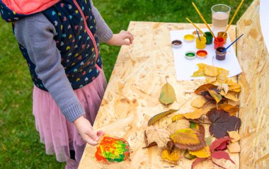 Sonbahar yaprakları çizen çocuk. Seçici odaklanma. Çocuk.