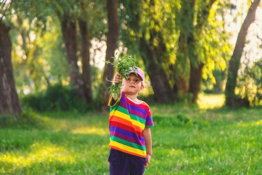 Child in ragweed flowers allergy. Selective focus. Kid. clipart