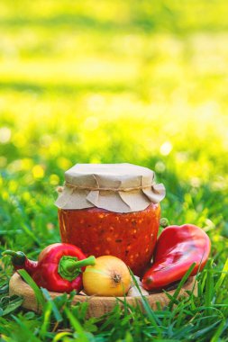 Preserving adjika in a jar. Selective focus. food. clipart