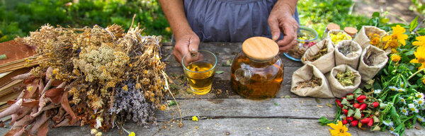 Medicinal herbs and tea old woman. Selective focus. Nature.