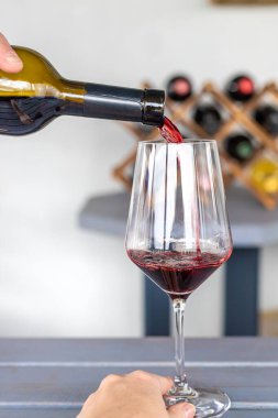 Ellerinde bir kadeh kırmızı şarap. Seçici odaklanma. iç.