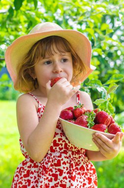 Bahçesinde çilek olan çocuk. Seçici odaklanma. Çocuk.