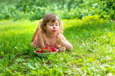 Bahçesinde çilek olan çocuk. Seçici odaklanma. Çocuk.