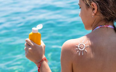 Çocuğun sırtında güneş kremi var. Seçici odaklanma. çocuk.