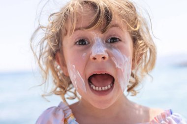 Çocuğun yüzünde güneş kremi var. Seçici odaklanma. çocuk.