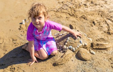 Çocuklar kumsalda kumla oynuyorlar. Seçici odaklanma. deniz.