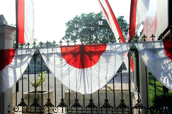 Stock image Yogyakarta, Indonesia, Aug 26, 2016. A red and white cloth resembling the Indonesian national flag was attached to the fence as decoration to enliven moment of celebrating Indonesian independence.