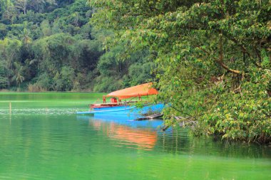 A traditional boat on the shores of Lake Linow, a volcanic lake with high sulfur content, Tomohon, North Sulawesi. clipart