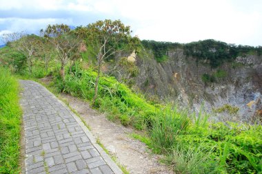 Pedestrian path at the top of crater wall of Mount Mahawu, Tomohon, North Sulawesi. clipart