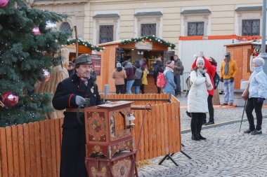 Brno, Czech Republic-November 26, 2023: Man with barrel organ  at Christmas market on the Cabbage Market on November 26, 2023 Brno, Czech Republic