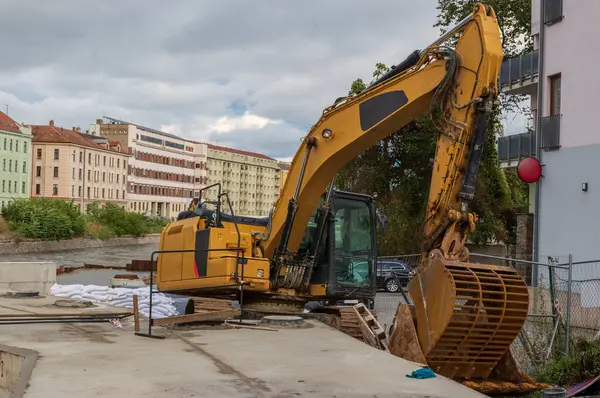 stock image Yellow excavator on the bank of the river Svratka, Brno, Czech republic, floods after storm Boris, September 15, 2024.