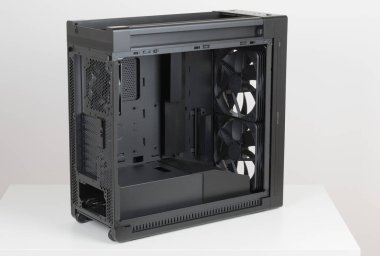 Side view of empty  big tower, PC case, chassis, without upper and  tempered-glass left panel. At the bottom is a cover for power supply unit. 