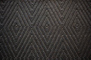 dark brown carpet texture shot from above.Abstract ethical geometric pattern with maze,Seamless background  lines.