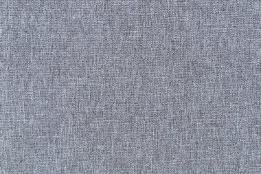 Yakın plan mavi ve gri kumaş arkaplan olarak kullanılan desenli bir kumaş arkaplan oluşturur.