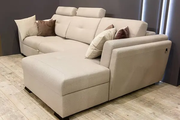 Corner sofa in modern interior design room in beige colors