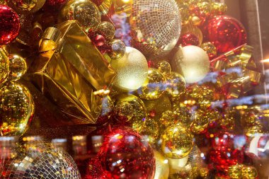 Christmas decoration hanging on a store window  and reflection of the city clipart