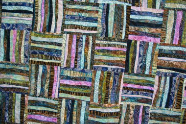 Farklı renkte kareleri olan yamalı bir yorgan. Soyut arkaplan