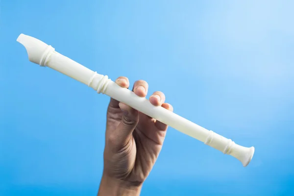 Plastic flute handle on a blue background