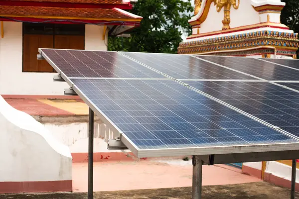 Large solar panels in the public space of a temple in Asia are mostly being used. to reduce costs