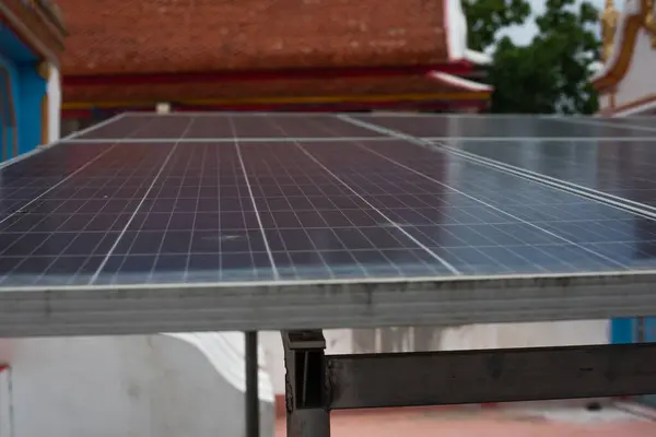 Large solar panels in the public space of a temple in Asia are mostly being used. to reduce costs