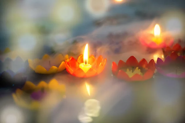 flower shaped candle Light it and place it on the surface of the water to make a wish. There will be smoke and bokeh light that makes it blurry