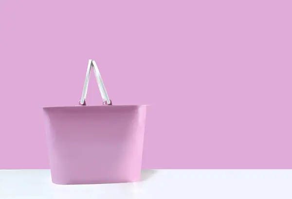empty pink basket placed on a white background pink backdrop