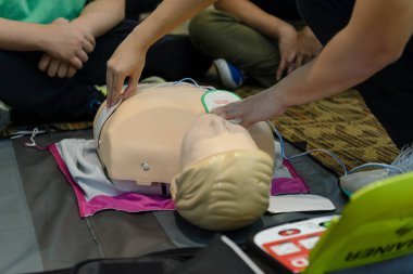 First aid cardiopulmonary resuscitation course using automated external defibrillator device - AED training. selective focus placing electrode