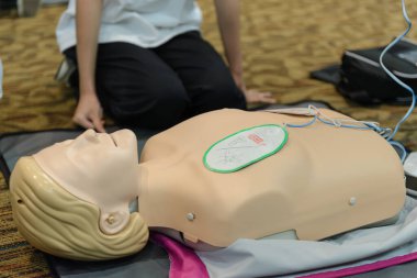 First aid cardiopulmonary resuscitation course using automated external defibrillator device - AED training. selective focus placing electrode