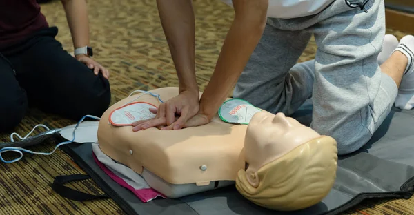First aid cardiopulmonary resuscitation course using automated external defibrillator device - AED training. selective focus placing electrode